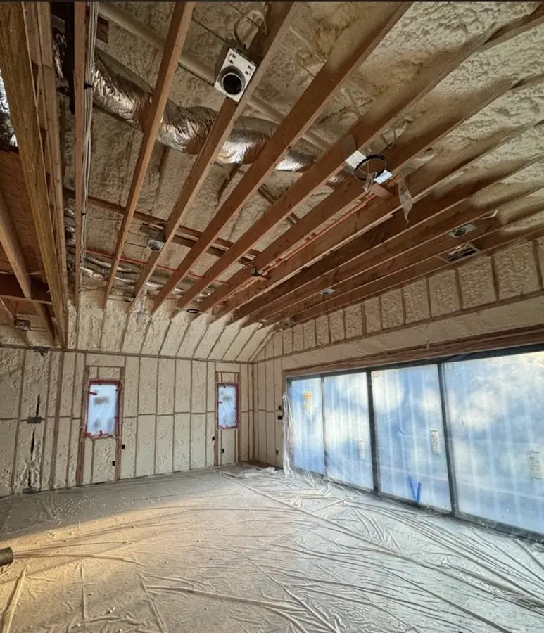 Interior walls and ceiling insulated with spray foam during new construction in New Haven